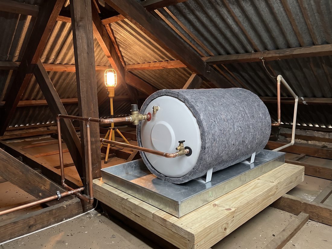 Neat geyser replacement by Andy Plumbers in a 1970s Hurlingham family home, with new copper pipework, drip tray and pressure control valve