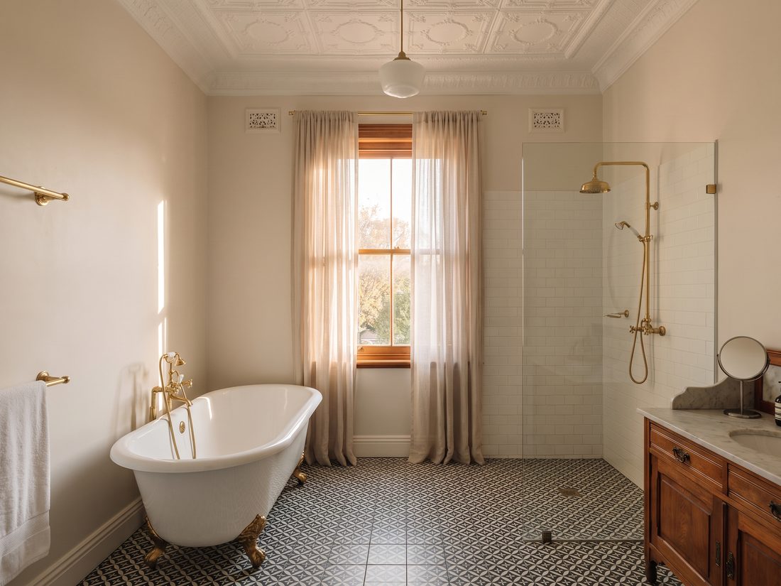 Bathroom renovated by Andy Plumbers in an Edwardian Melville home, with the pressed-steel ceiling and original features kept